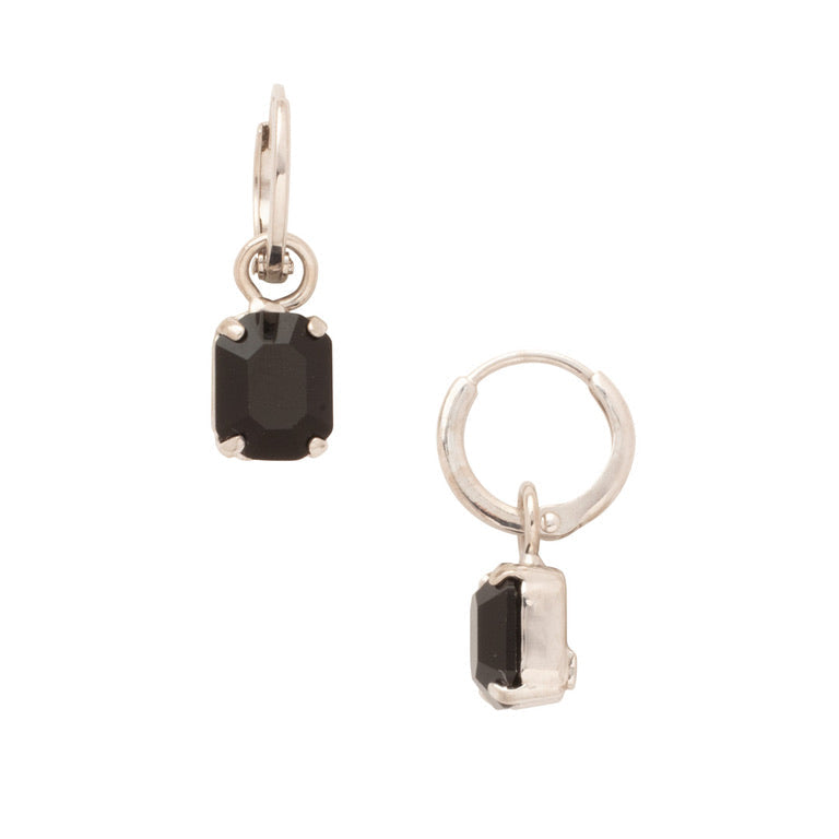 Pair of earrings with black gemstones on a white background