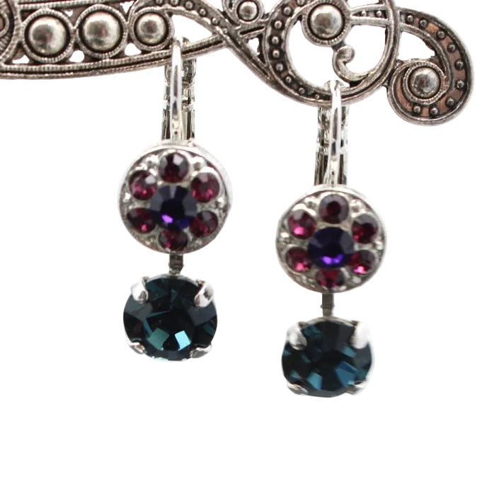 Pair of earrings with dark gemstones on a white background