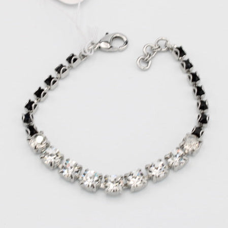Silver bracelet with black beads on a white background