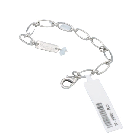 Silver bracelet with a tag on a light gray background