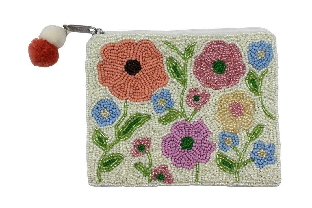 Beaded pouch with floral design and pom-pom on a white background