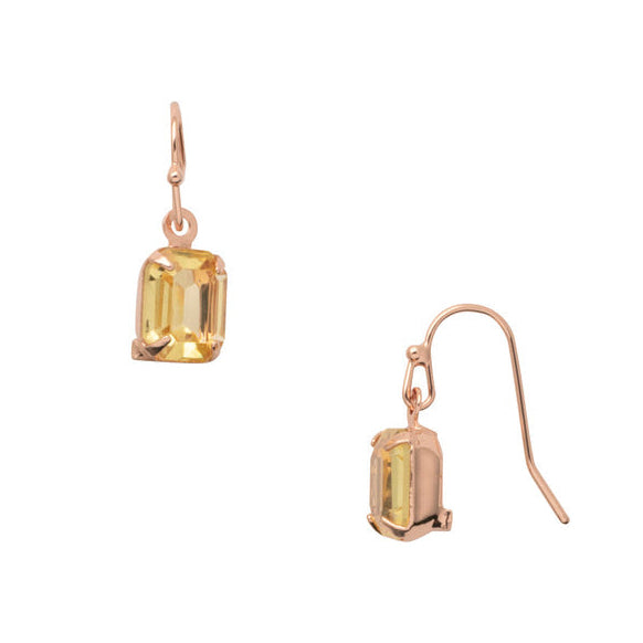 Gold earrings with yellow gemstones on a white background