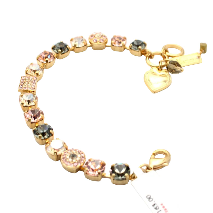 Gold bracelet with colorful gemstones and a heart charm on a white background
