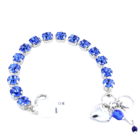 Bracelet with blue gemstones and a heart charm on a white background