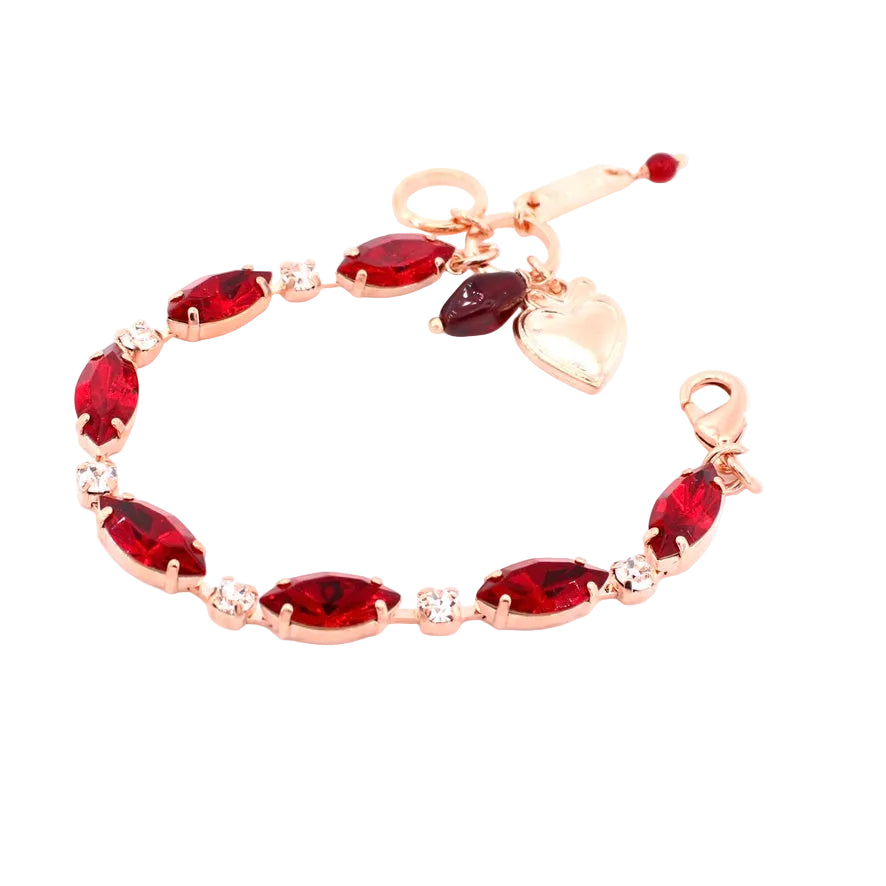 Rose gold bracelet with red gemstones on a white background