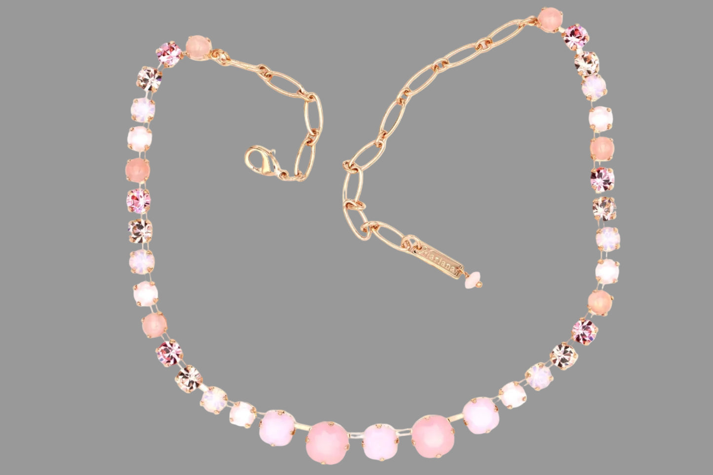 Necklace with pink beads and gold chain on a white background