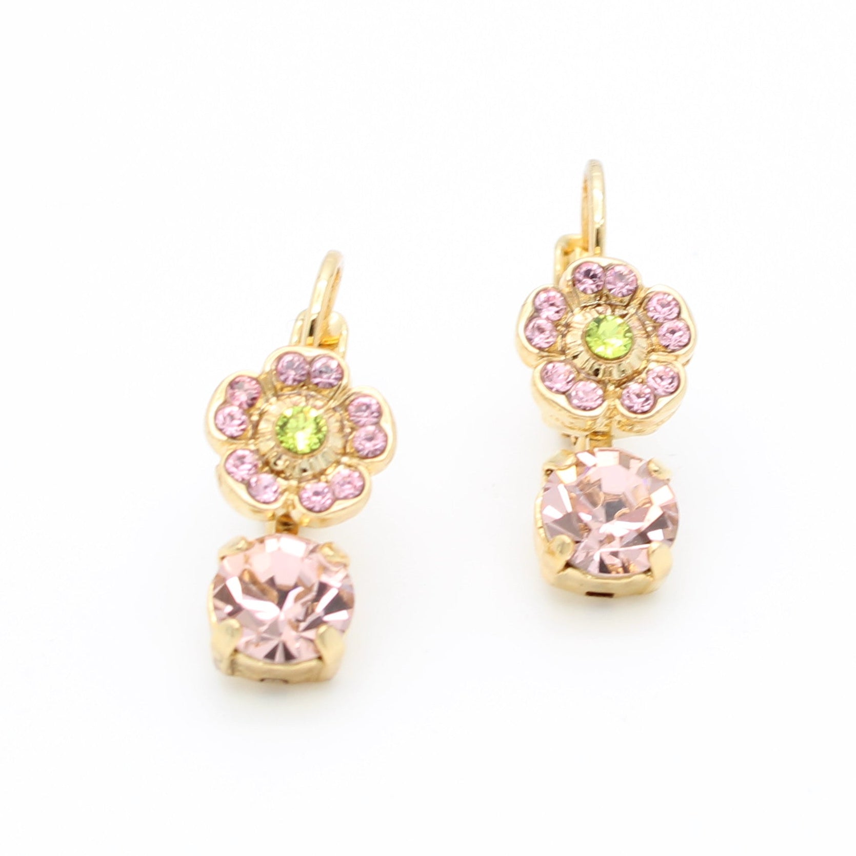 A pair of gold dangle earrings featuring a small yellow-green center stone surrounded by pink stones, with a larger pink stone hanging below, set against a plain white background.