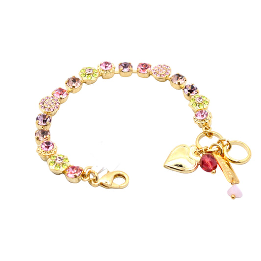 Gold bracelet with colorful beads and charms on a white background