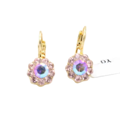 A pair of gold leverback earrings with iridescent pink and purple rhinestone flower centers, shown next to a white product tag on a white background.