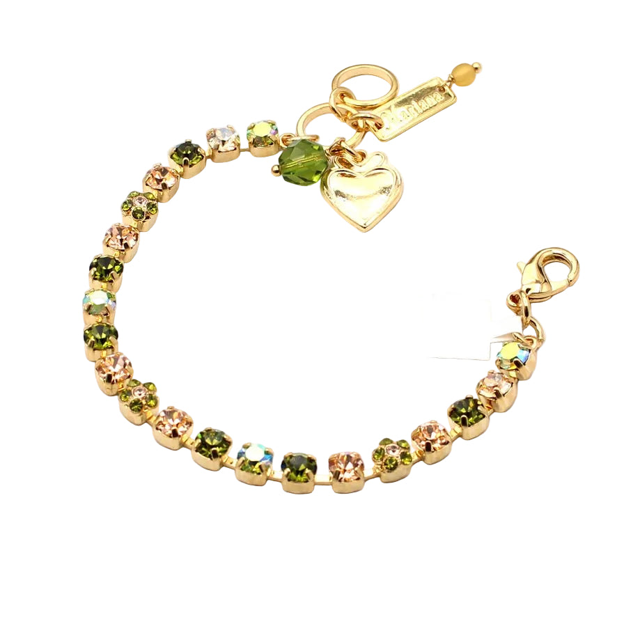 Gold bracelet with green and peach crystals and heart charm on a white background