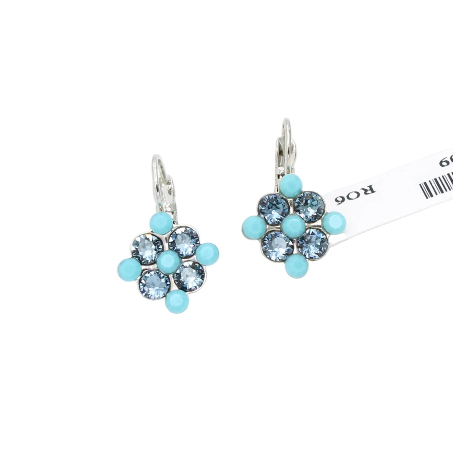 Pair of floral earrings with blue gemstones on a white background