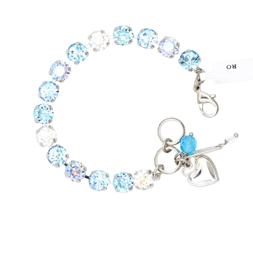 Bracelet with blue and clear crystal beads and a heart charm on a white background