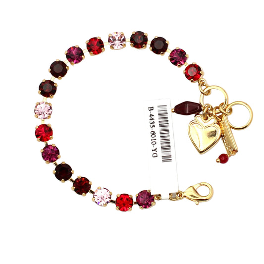 Bracelet with red and pink gemstones and a heart charm on a white background