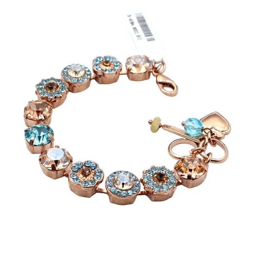 Bracelet with rose gold and blue crystal charms on a white background