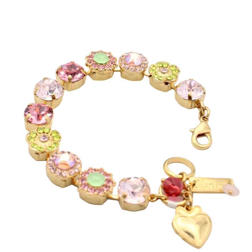 Colorful bracelet with floral charms and a heart-shaped tag on a white background