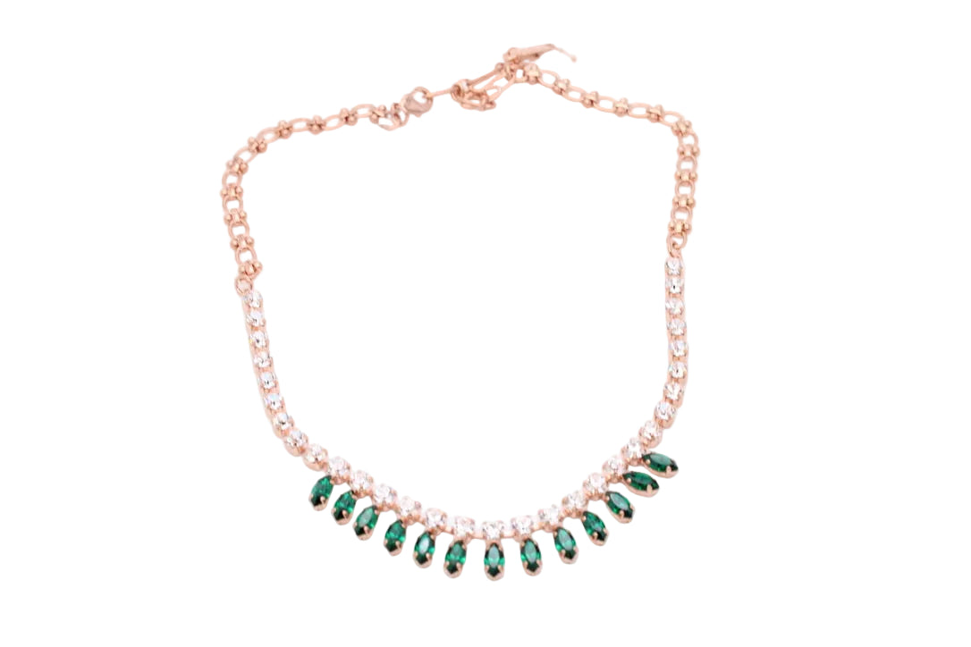 Rose gold necklace with a row of green marquise-cut crystals and small clear stones, displayed on a white background.