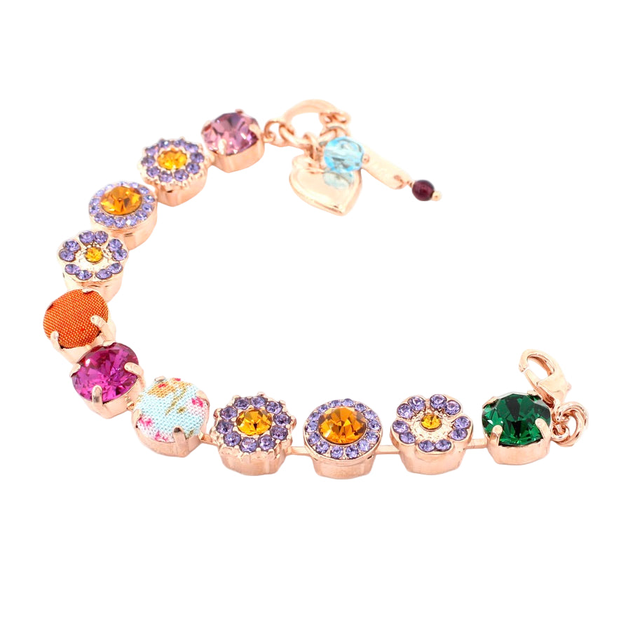 Multicolored gemstone bracelet with heart and flower charms on a white background