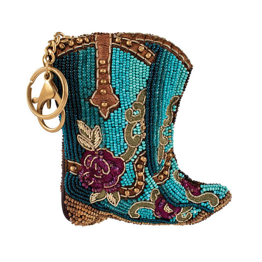 Decorative keychain shaped like a beaded cowboy boot with intricate designs on a white background