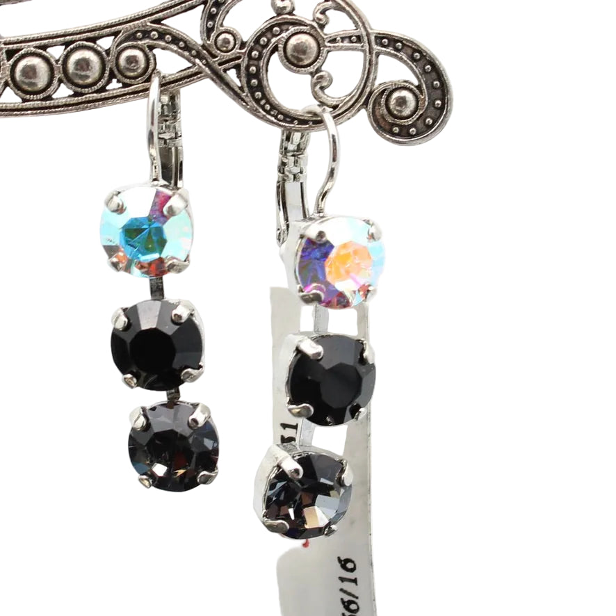Pair of earrings with black and clear gemstones on a white background