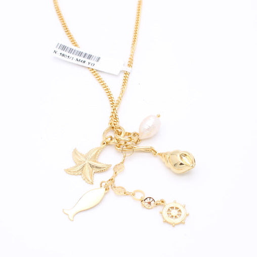 A gold-toned chain necklace with multiple dangling charms, including a starfish, a small fish silhouette, a shell, and a sun face, shown on a plain white background.