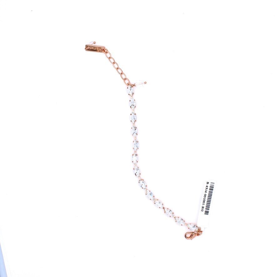 A rose gold chain bracelet with clear faceted gemstones, shown on a plain white background with its retail tag attached.