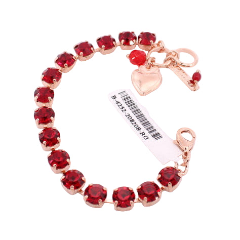 Bracelet with red gemstones and gold accents on a white background