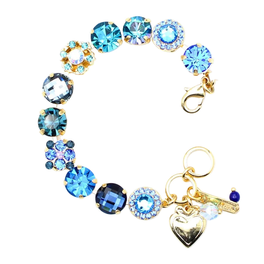 Bracelet with blue gemstones and gold accents on a white background