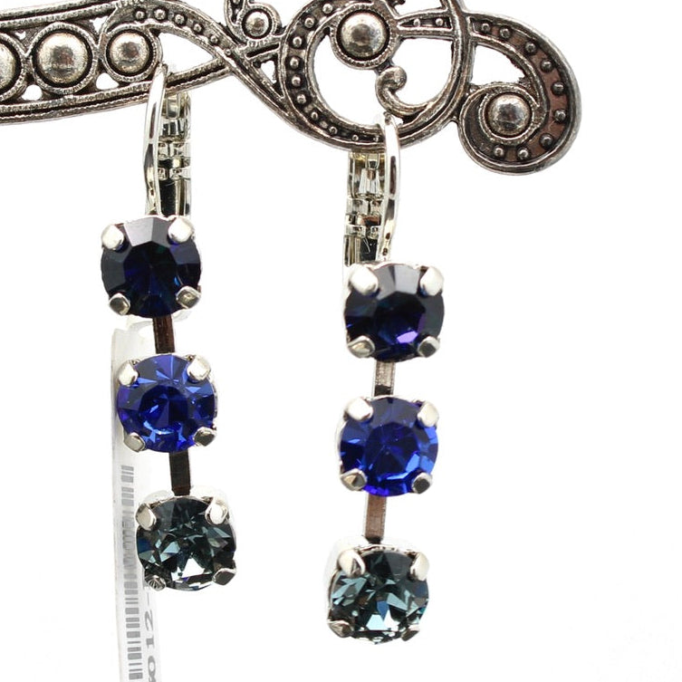 Silver earrings with blue gemstones on a white background
