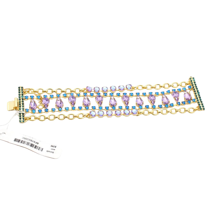 Gold bracelet with colorful stones on a white background
