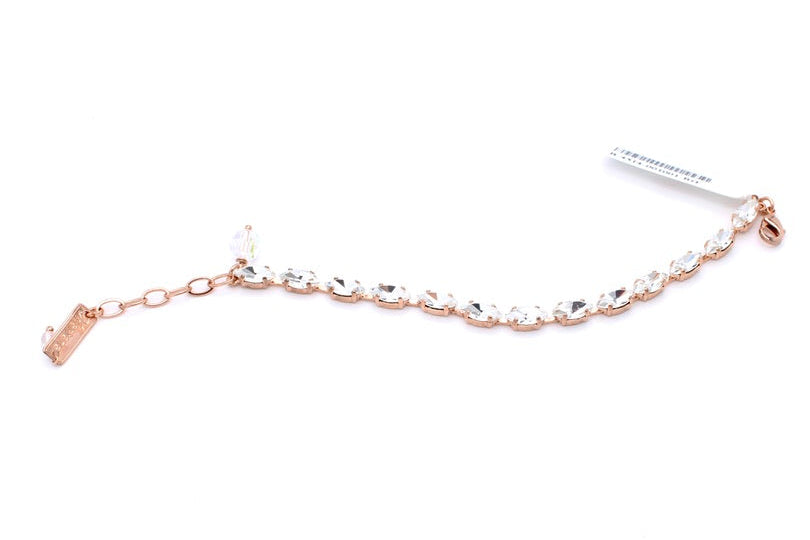 A delicate rose gold chain bracelet adorned with clear faceted crystals, shown on a plain white background with its paper tag attached.
