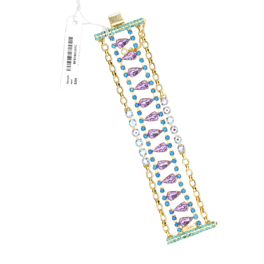 Gold bracelet with purple and blue gemstones on a white background