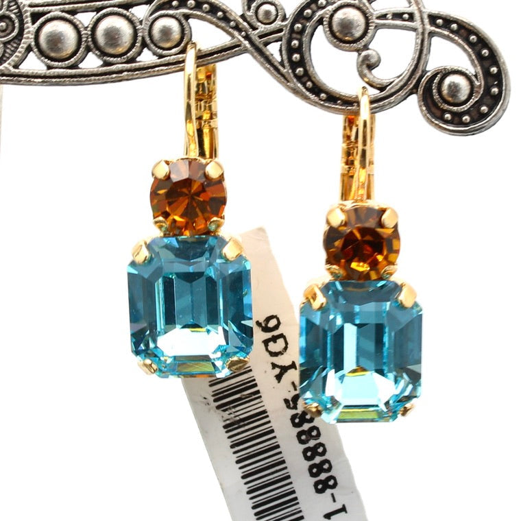 Pair of earrings with blue and brown gemstones on a white background