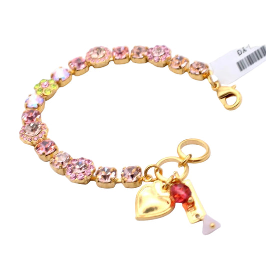 Bracelet with pink gemstones and gold heart charm on a white background