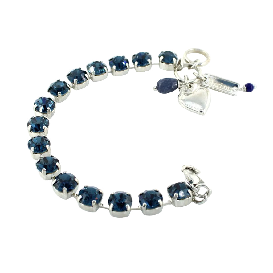 Silver bracelet with blue gemstones on a white background