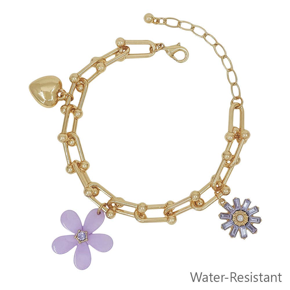 Gold bracelet with purple flower charms on a white background