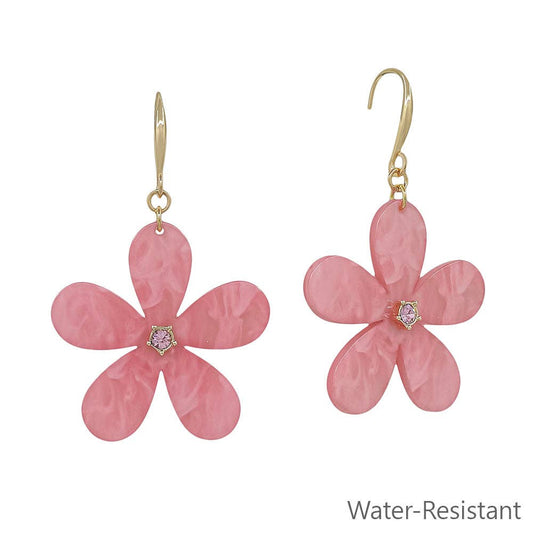 Pink flower-shaped earrings with gold hooks on a white background